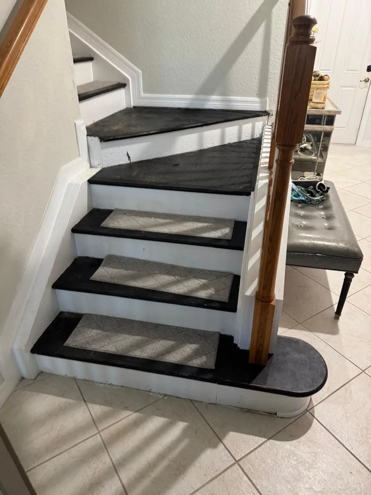 Before: Painted stairs with carpet pads, rebuilt with vinyl plank treads and white risers